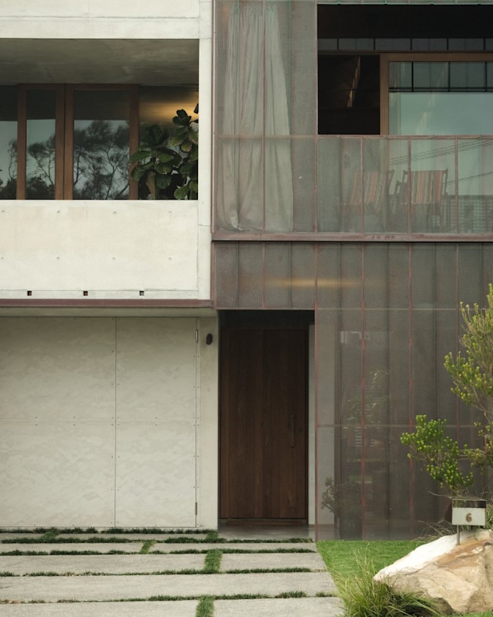 The home’s front and rear facades feature distinctive perforated copper screens that allow for both light and privacy.