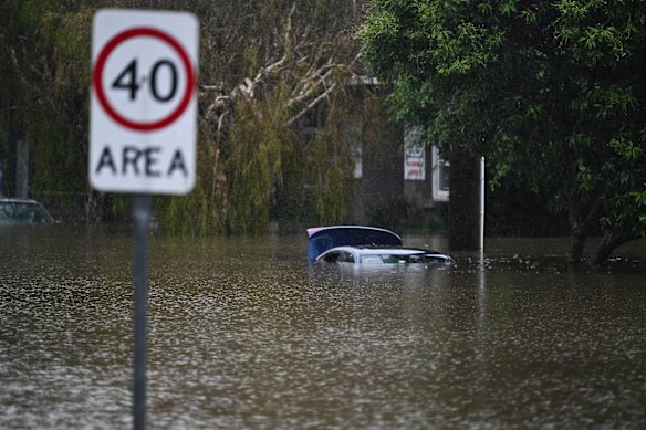 Cars are submerged in a flooded street in Newmarket.