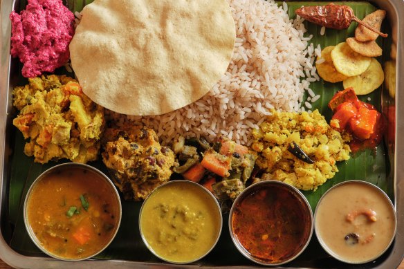 Sadhya, a traditional dish of 12 different elements served on a banana leaf.