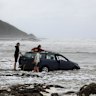 Owners of the submerged cars retrieving their valuables after flooding at Wye River. 