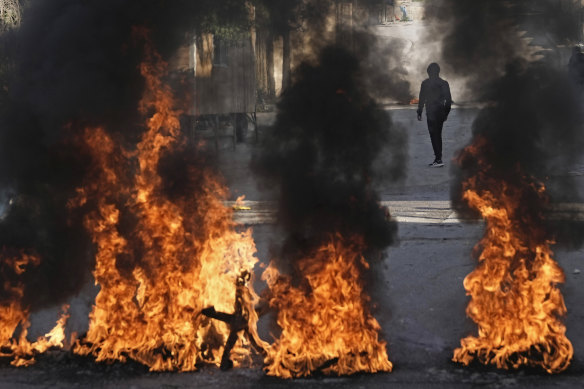Palestinian demonstrators burn tires in a protest against a deadly Israeli army raid at Aida Refugee camp.
