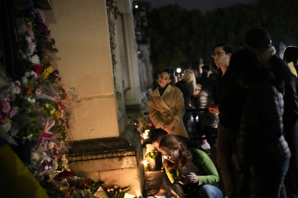 Crowds gather outside Buckingham Palace in London on Friday after the Queen’s death was announced.