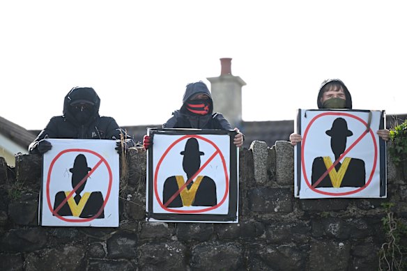 Protesters hold anti-Orange Order signs in Portadown.