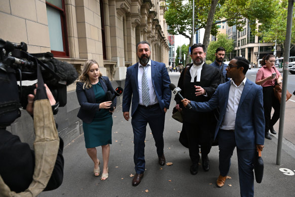 Laith Hanna (second from the left) outside the Supreme Court of Victoria on Monday.