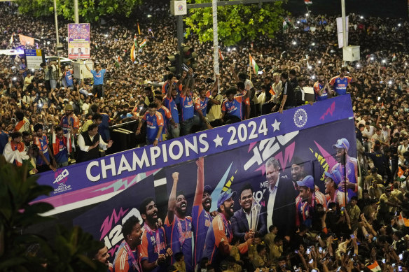 Crowds surround the double-decker bus at the parade celebrating India’s T20 World Cup victory.