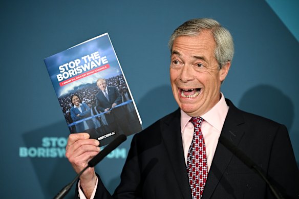 Nigel Farage holds a copy of a newly commissioned report into migration as he speaks during a press conference on April 13 in London. Reform UK has pledged to told hold a national inquiry into the so-called “Boriswave” migration surge between 2021 and 2024.