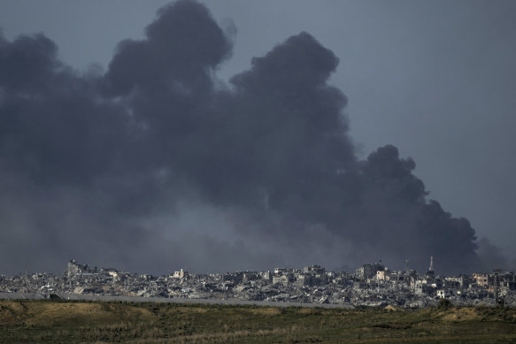 Smoke rises following an Israeli bombardment in the Gaza Strip, as seen from southern Israel on December 26.