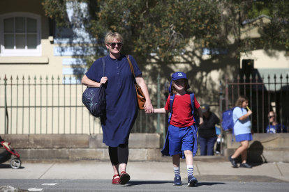 Louise Gough, with her son Magnus outside Annandale Public School, believes her son is better off at school now than at home. 