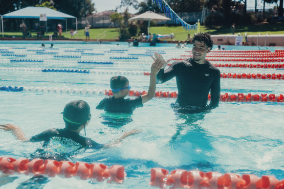 Affouf gives Adam and Mohammed encouragement at Roselands pool.
