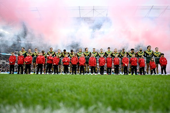 Daniel Jarvis links arms with Munster during the Australian national anthem.