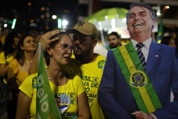 Supporters of Jair Bolsonaro react after it became apparent he had not won the presidential election.