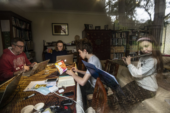 David Gamble and Jennifer Crawford with their two children, Imogen, 10, and Rory, 14, working and learning at home in Balmain.
