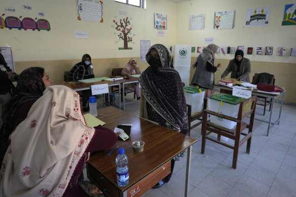 A female voter checks in to receive her ballot paper in Islamabad, Pakistan on Thursday.
