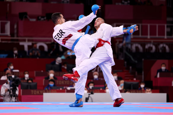 Steven Da Costa, right, of France competes against Hamoon Derafshipour of the IOC Refugee Team during the men’s karate kumite -67kg elimination round on Thursday.