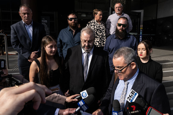Brett Button, the driver of a charter bus that rolled and killed 10 weddings guests in the Hunter Valley, stands with head bowed as his lawyer reads an apology in Newcastle.