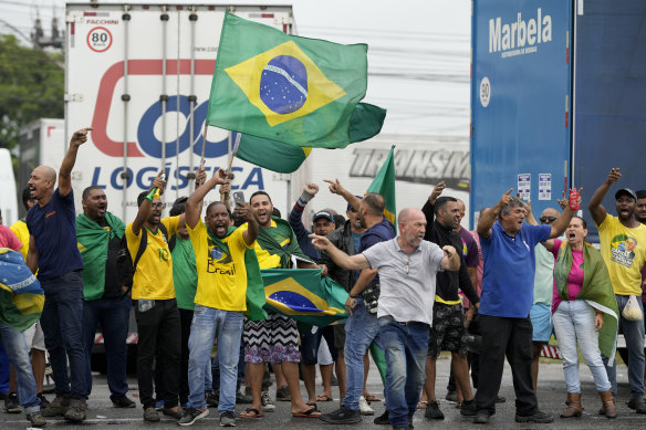 Supporters of President Jair Bolsonaro block a highway to protest his run-off election loss.