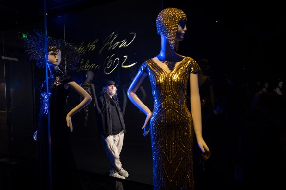 Designer Michael Schmidt with some of his head pieces at the opening of the Alexander McQueen exhibition at the NGV. 