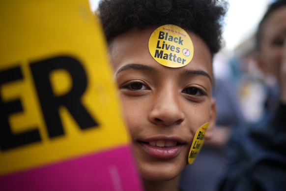 A young boy wears Black Lives Matter stickers at the protest.