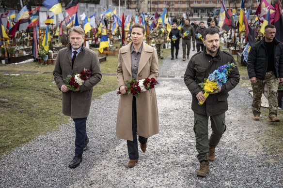 Zelensky with Danish Prime Minister Mette Frederiksen (centre) and her husband Bo Tengberg (left) on Friday at a wreath laying ceremony at a cemetery in Lviv, Ukraine.