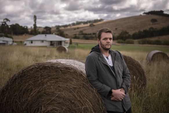 Daniel Sutton at his home in Kings Plains, with the mine site in the background.