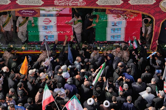 Mourners surround the flag-draped coffins of Iranian generals and nuclear scientists killed in the Israeli strikes.