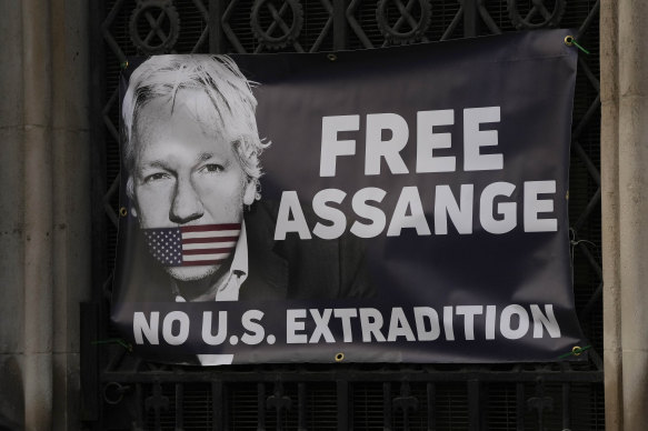 Supporters of Julian Assange fixed a large banner to a railing outside the High Court in London last year.