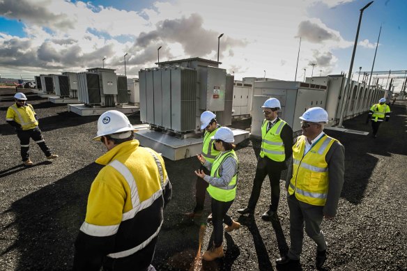 Energy minister Lily D’Ambrosio and workers walk around the Hazelwood big battery.