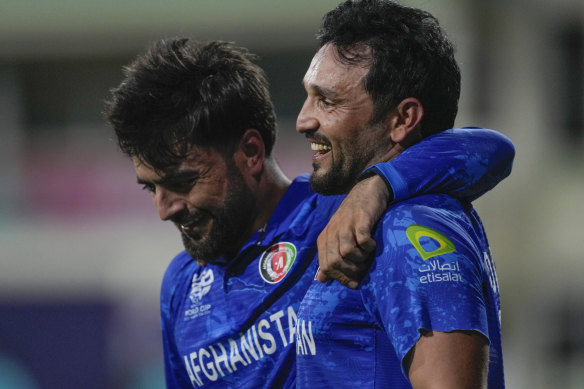 Afghanistan’s captain Rashid Khan, left, embraces teammate Gulbadin Naib. 