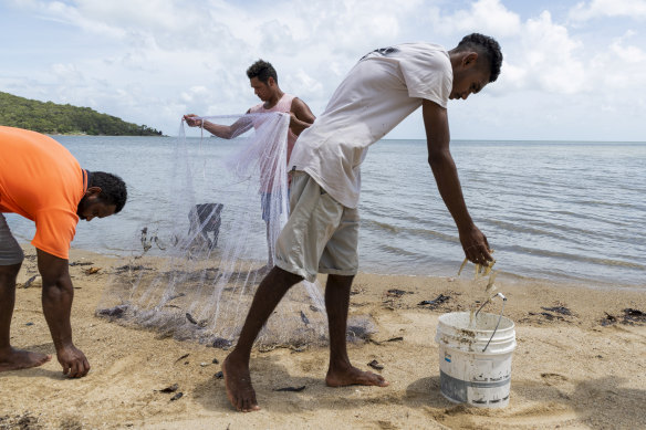 Yarrabah residents casting netting for prawns in far north Queensland.