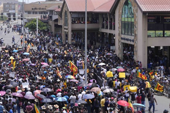 Anti-government protesters shout slogans outside the Galle International Cricket Stadium during the second day of the second test cricket match between Australia and Sri Lanka in Galle on Saturday.