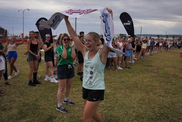 An emotional Natalia Hogan crosses the finish line at Empire Park in Newcastle on Sunday afternoon, having run overnight from Sydney to raise money for Samaritans through Nedd’s Uncomfortable Challenge.