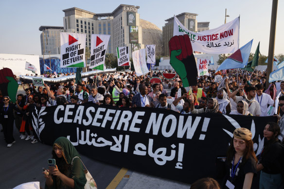 Activists march in protest on day nine of COP28.