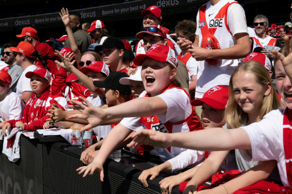 Swans fans collect autographs after a training day. 