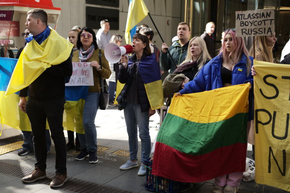 Ukrainian and Lithuanian activists protest at Atlassian’s office in Sydney on Tuesday.