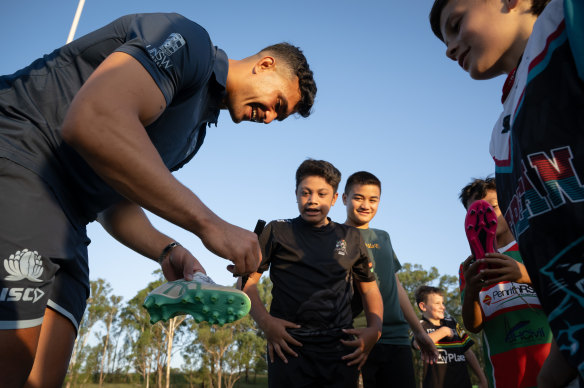 Joseph-Aukuso Suaalii signs autographs for young players at Penrith RSL Silverbacks Junior Rugby Union Club.