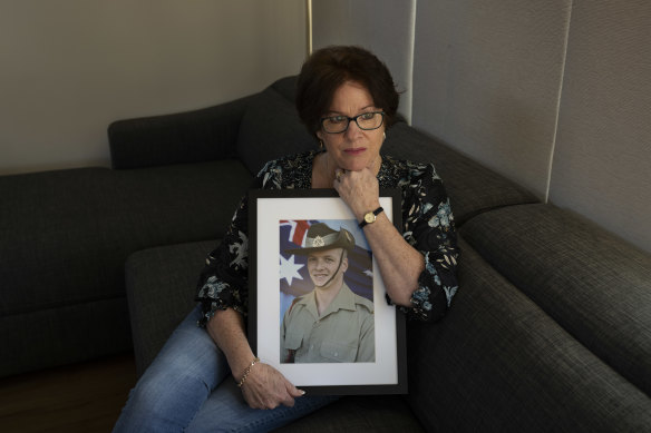 Colleen Pillen with a portrait of her son Michael Powers, who took his own life.