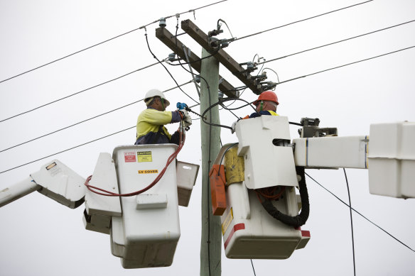 Workers installing NBN fibre optic cable.