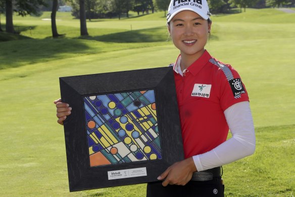 Shoulders squared: Minjee poses with her trophy after winning her fifth LPGA title.