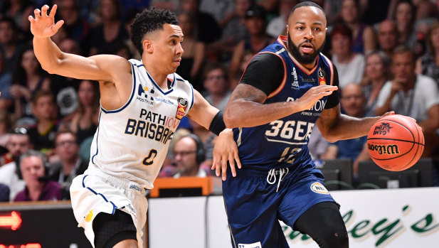 Travis Trice from the Brisbane Bullets (left) and Shannon Shorter of the Adelaide 36ers contest the ball during their Round 19 NBL match at Titanium Arena in Adelaide on Saturday.