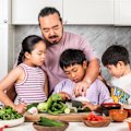 Adam Liaw cooking with his kids.