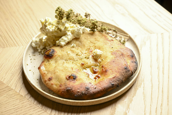 Pita, cooked in Tzaki’s wood oven, is served with feta butter.