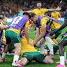 Connor Metcalfe is swarmed by Socceroos teammates.