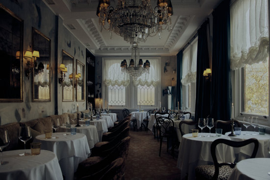 The main salon at Gigi is kitted out with antique crystal chandeliers, hand-painted walls and lace-frilled velvet club chairs.