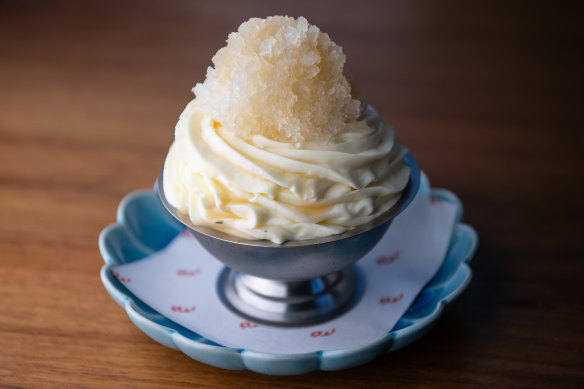 Chocolate flan under a crown of Chantilly cream and pear granita.