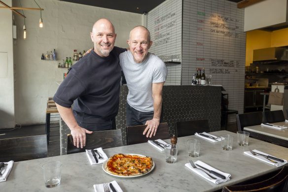 Sean Kierce (right) is handing  Ladro Gertrude to Mark Natoli, who owns Melbourne’s oldest pizza place.