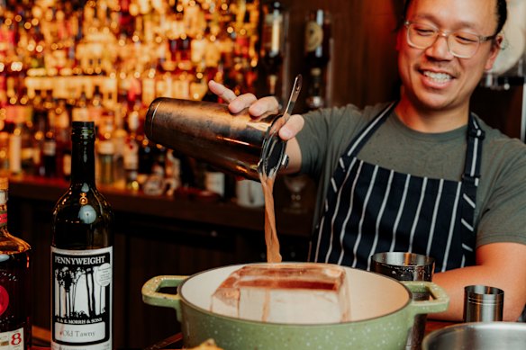 Pour the punch over the ice block to bring the temperature down.