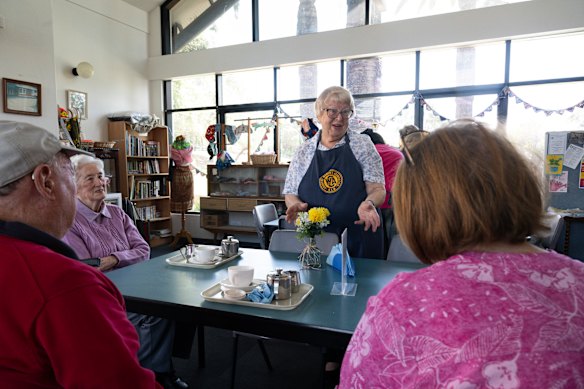 Eastwood CWA President Margery East serves Devonshire tea at the volunteer-run tea room.