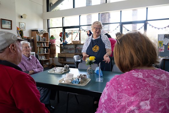 Eastwood CWA President Margery East serves Devonshire tea at the volunteer-run tea room.