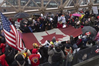 People carrying a large Canadian flag march on Brooklyn Bridge during an anti-vaccine mandate protest ahead of possible termination of New York City employees due to their vaccination status in New York. 