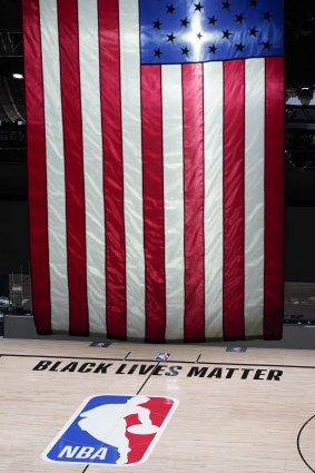 Black Lives Matter is displayed near the NBA logo in an empty basketball arena Friday in Lake Buena Vista, Florida. 